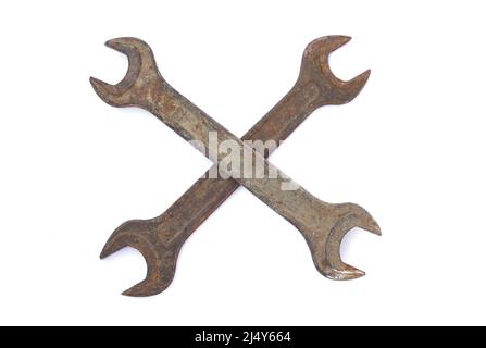 Two old rusty crossed wrenches isolated on white background Stock Photo