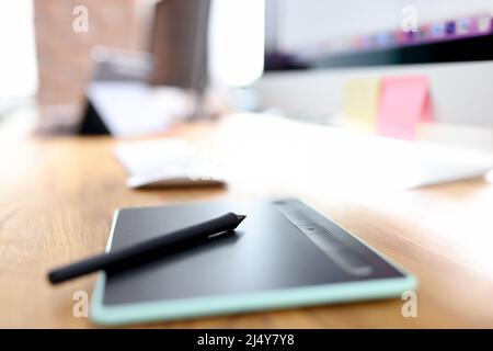 Graphic tablet and stylus on designer desktop closeup Stock Photo