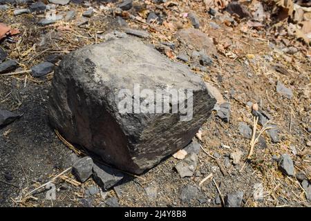Big rock in forest in India. Naturally cut single isolate Big stone rock in jungle mountain ghat of India Stock Photo