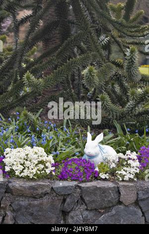 A white ceramic bunny on display for the Easter holiday, at Butchart Gardens in Victoria, BC, Canada. Stock Photo