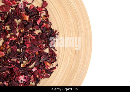 Dried leaves Sudanese rose in wooden dish on white, herbal tea karkade Stock Photo