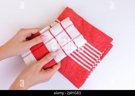 Woman holding new red checkered kitchen towels. Cooking, cleaning, laundry concept. Stock Photo
