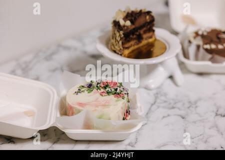 Three different bento cake on white table. Small bento cake for one person as a gift for the holiday Stock Photo