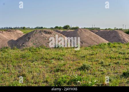 Land of Construction in rural Area in Argentina. Piles of dirt hauled on lots prepared for construction. Horizontal Stock Photo