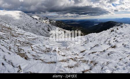 Snowy mounts under gloomy sky Stock Photo