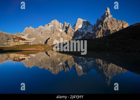 The Pala Group reflecting on a small ephemeral lake as seen from Passo Rolle in the late afternoon light Stock Photo