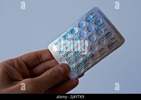 RIO DE JANEIRO, BRAZIL - APRIL 30, 2021: Blister pack of finasteride pills on hand Stock Photo