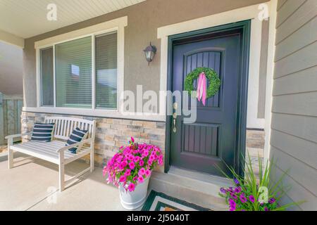 Porch of a house with pillows on the white bench near the windows Stock Photo