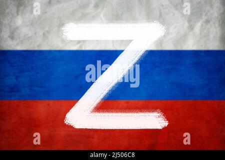 Letter Z on Russian flag background, military symbol of Russia used in Russia-Ukraine war. Painted logo Z for Russian army force. Concept of World fam Stock Photo
