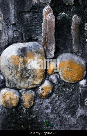 Old concrete wall with stones and boulders creating an abstract art design Stock Photo