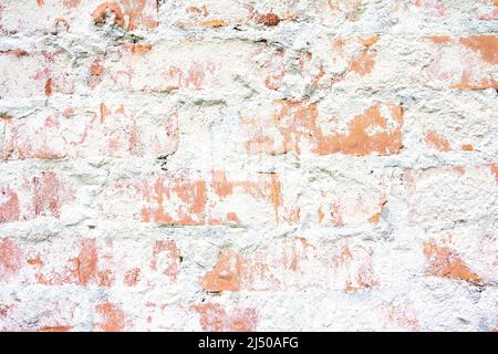 Old brick wall. Abstract grunge background with brick wall texture. Red broken bric and white concrete. Stock Photo