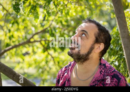 Bearded mature man wearing a fuchsia shirt Stock Photo