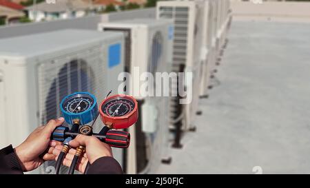 Technician checking the operation of the air conditioner Stock Photo