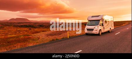 Motorhome camper van RV road trip. People on travel vacation adventure. Tourists in rental car campervan by view of mountains in beautiful nature Stock Photo