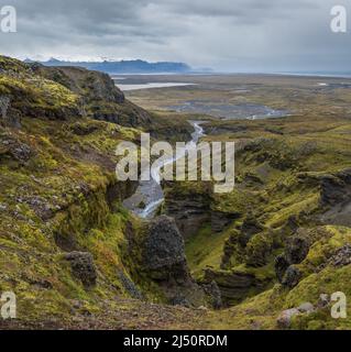 Beautiful autumn view from Mulagljufur Canyon to Fjallsarlon glacier with Breidarlon ice lagoon, Iceland and Atlantic Ocean in far. It is south end of Stock Photo