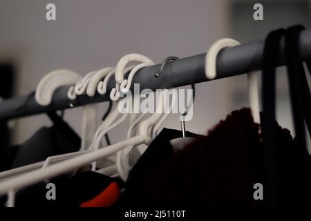 https://l450v.alamy.com/450v/2j5110t/detail-of-different-types-of-hangers-on-racks-with-clothing-2j5110t.jpg