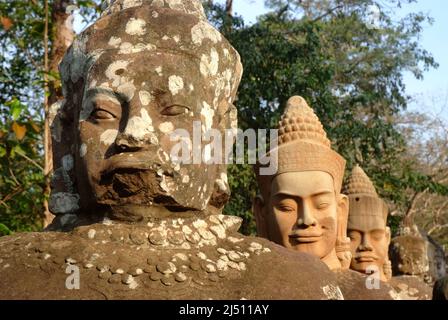 Ancient devas statues carved out of stones depicting the scene of Samudra Manthan (Devas Pulling Vasuki) at the  gate of Angkor Thom, Siem Reap, Cambo Stock Photo