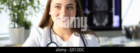 Woman doctor giving hand for handshake in clinic Stock Photo