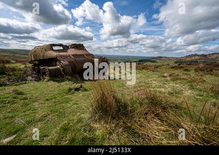 Abandoned Sherman tank in the Peak District National Park at The Roaches, Upper Hulme with Ramshaw Rocks in the distance. Stock Photo