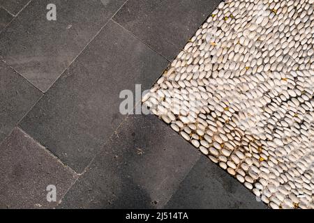 Background, minimal architectural pattern formed by the combination of a concrete floor and small stones, stone chips and gray ground Stock Photo