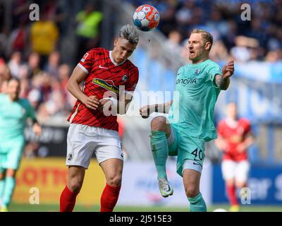 Nico SCHLOTTERBECK l. (FR) in duels versus Sebastian POLTER (BO), action, soccer 1st Bundesliga, 30th matchday, SC Freiburg (FR) - VfL Bochum (BO), on April 16th, 2022 in Freiburg/Germany. #DFL regulations prohibit any use of photographs as image sequences and/or quasi-video # Â Stock Photo