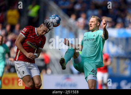 Nico SCHLOTTERBECK l. (FR) in duels versus Sebastian POLTER (BO), action, soccer 1st Bundesliga, 30th matchday, SC Freiburg (FR) - VfL Bochum (BO), on April 16th, 2022 in Freiburg/Germany. #DFL regulations prohibit any use of photographs as image sequences and/or quasi-video # Â Stock Photo