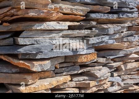 Slabs of natural stone stacked in layers. Folded flagstone. Horizontal photo. Stock Photo