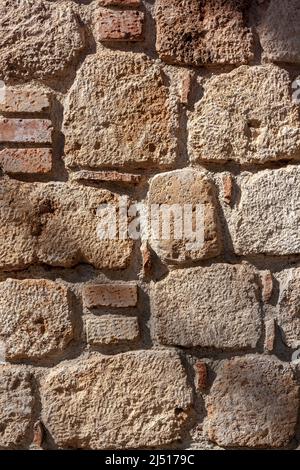 Antique closeup of old blocks of different sizes and mortars. Stock Photo