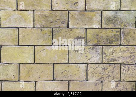 Background brick wall texture of light beige greenish shades of large blocks. Stock Photo