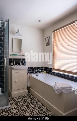 Abbey Woburn 19th century design floor tiles in bathroom of Grade II listed 1820s London cottage, UK Stock Photo