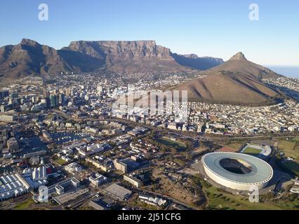 Cape Town, South Africa - 19 April 2022: Aerial view over Cape Town, with Cape Town stadium and Table Mountain . Stock Photo