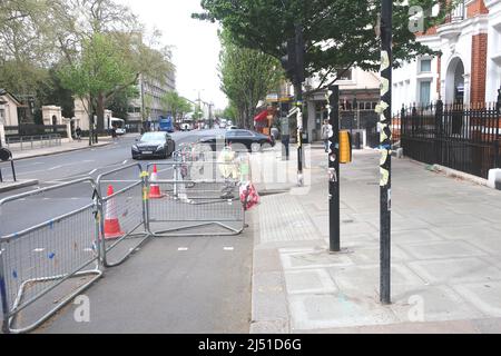London.UK. April 19th 2022.Westminster Council tear down ant-war placards and posters outside Russian Embassy in Kensington. Credit: Brian Minkoff /Alamy Live News Stock Photo