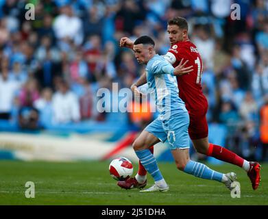 LONDON, ENGLAND - APRIL 16: Manchester City's Phil Foden holds of Liverpool's Jordan Henderson during FA Cup Semi-Final between Manchester City and Li Stock Photo