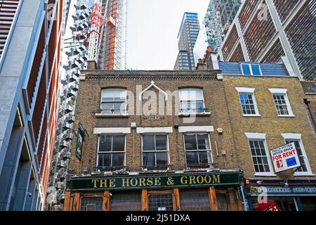 The Horse & Groom traditional English pub exterior surrounded by new luxury tower blocks The Stage Shoreditch apartment building flats London EC2A  UK Stock Photo