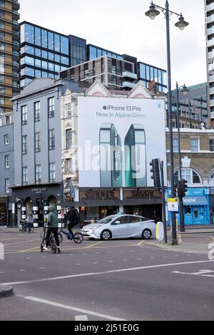 Apple Green iPhone 13 Pro advert billboard Commercial Street corner with Norton Folgate traffic intersection in Shoreditch London E2 UK  KATHY DEWITT Stock Photo