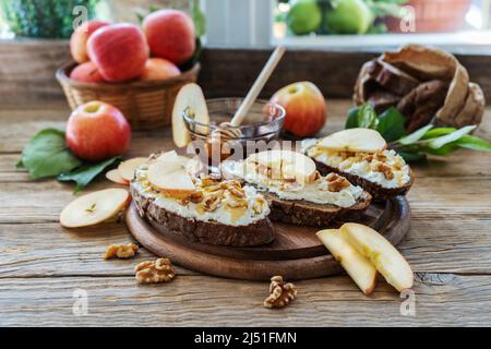 Bread slices with cottage cheese, honey, apples and nuts Stock Photo