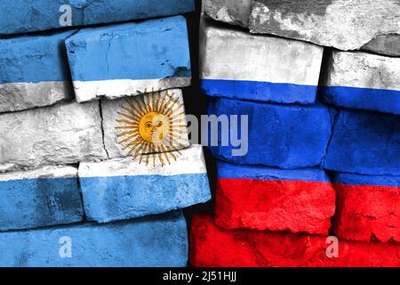 Concept of the relationship between Argentina and Russia with two painted flags on a damaged brick wall Stock Photo