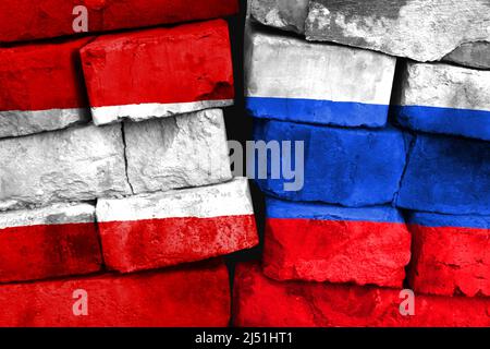 Concept of the relationship between Austria and Russia with two painted flags on a damaged brick wall Stock Photo