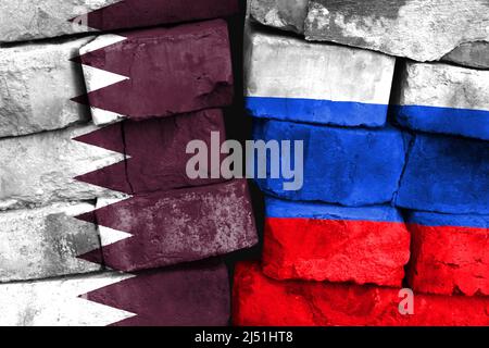 Concept of the relationship between Qatar and Russia with two painted flags on a damaged brick wall Stock Photo