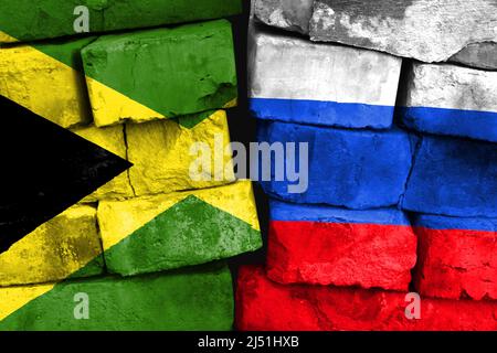 Concept of the relationship between Jamaica and Russia with two painted flags on a damaged brick wall Stock Photo