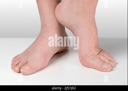 men feet after pedicure on white background. Close up well-groomed feet of an adult man. pedicure and foot care cosmetics Stock Photo