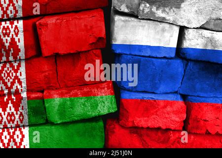 Concept of the relationship between Belarus and Russia with two painted flags on a damaged brick wall Stock Photo