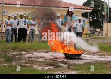 porto seguro, bahia, brazil - november 3, 2010: person puts out fire during firefighting training in Porto Seguro city. Stock Photo