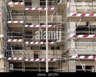 Scaffolding on the external facade of a new building under construction in Dubai, United Arab Emirates. Construction site and safety concept. Stock Photo