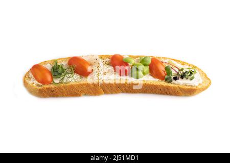 Long white bread sandwich with cream cheese, tomatoes and microgreen isolated on white background. side view, close up. Stock Photo