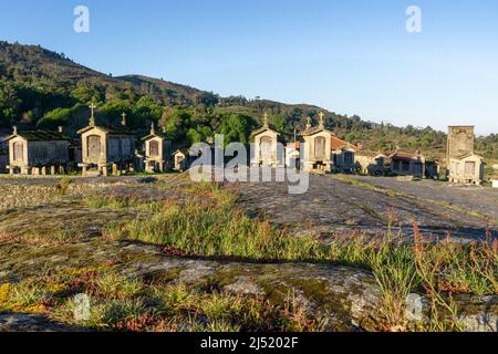 Warm morning light over granaries and stone storage sheds in the village of Lindoso in Portugal Stock Photo