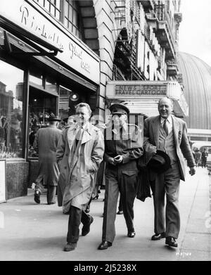 JOHN MILLS M.E. CLIFTON JAMES and CECIL PARKER walking past News Cinema along Marylebone Road near Baker Street with newly opened London Planetarium in the background during location filming of I WAS MONTY'S DOUBLE 1958 director JOHN GUILLERMIN writers Bryan Forbes and M.E. Clifton James Associated British Picture Corporation (ABPC) Stock Photo
