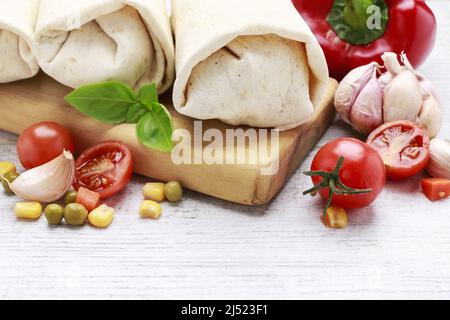 A burrito - mexican dish that consists of a flour tortilla with various ingredients. Traditional dish Stock Photo