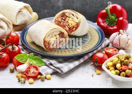 A burrito - mexican dish that consists of a flour tortilla with various ingredients. Traditional dish Stock Photo