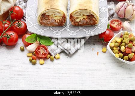 A burrito - mexican dish that consists of a flour tortilla with various ingredients. Traditional dish Stock Photo